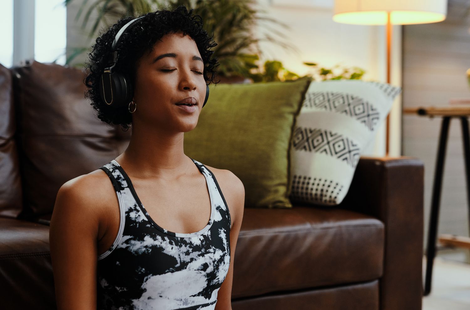 Woman Taking Deep Breath Meditating with Headphones
