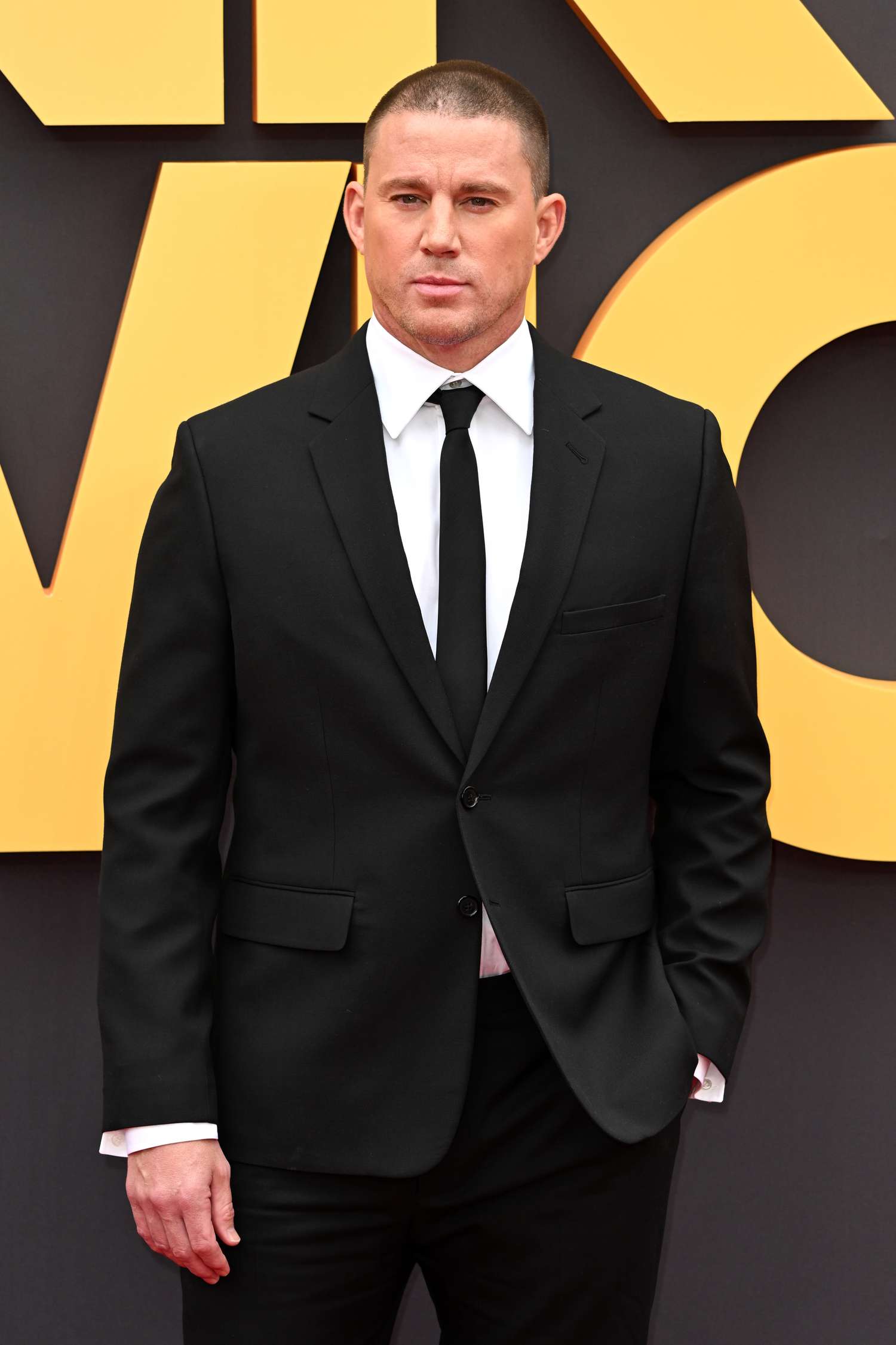 Channing Tatum wearing a black suit and tie 