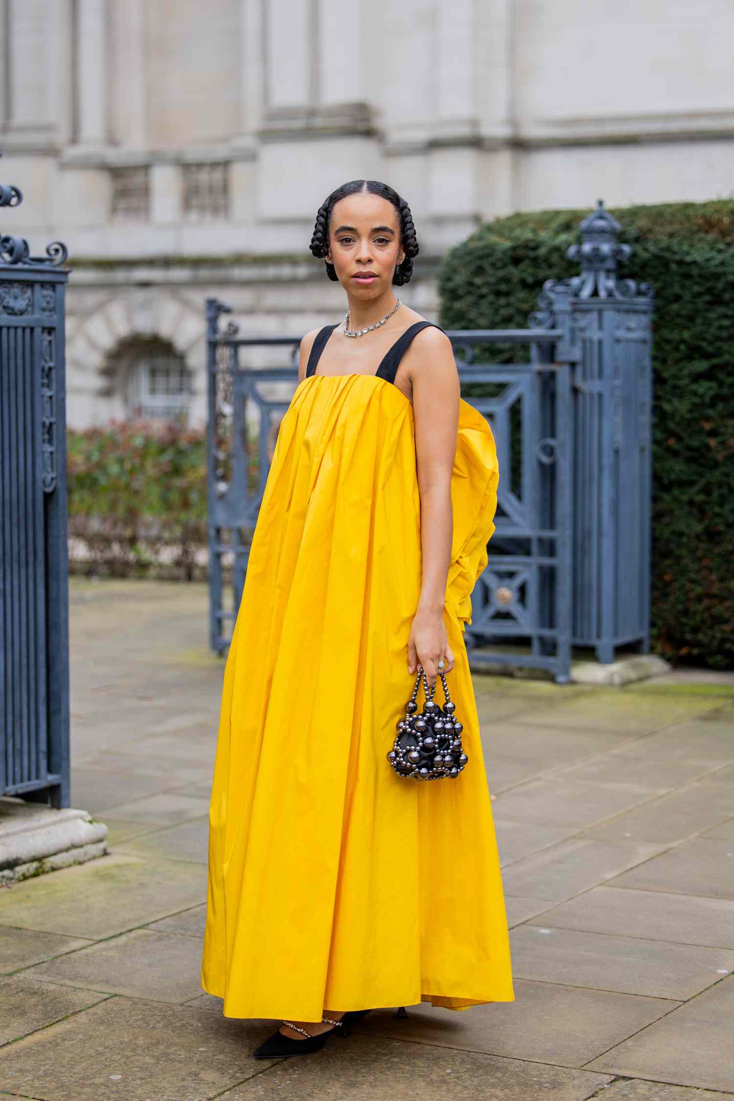 A woman wearing a yellow maxi dress