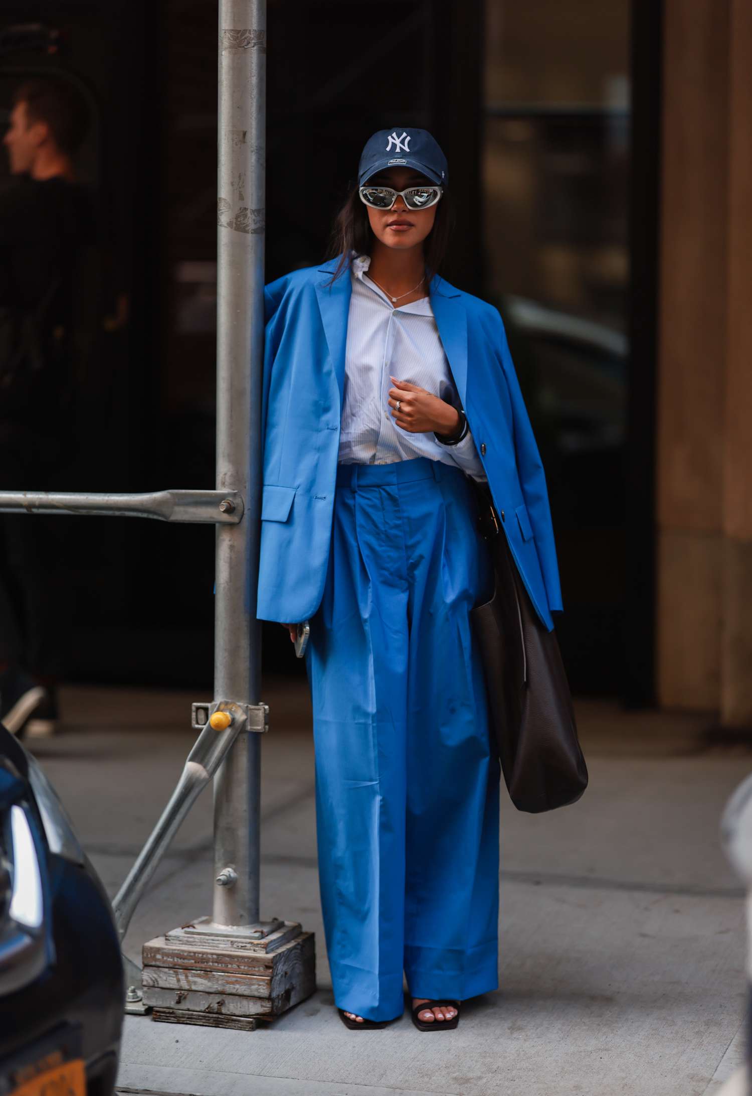 Woman wearing blue baseball cap with blue blazer and pants Sagittarius outfits