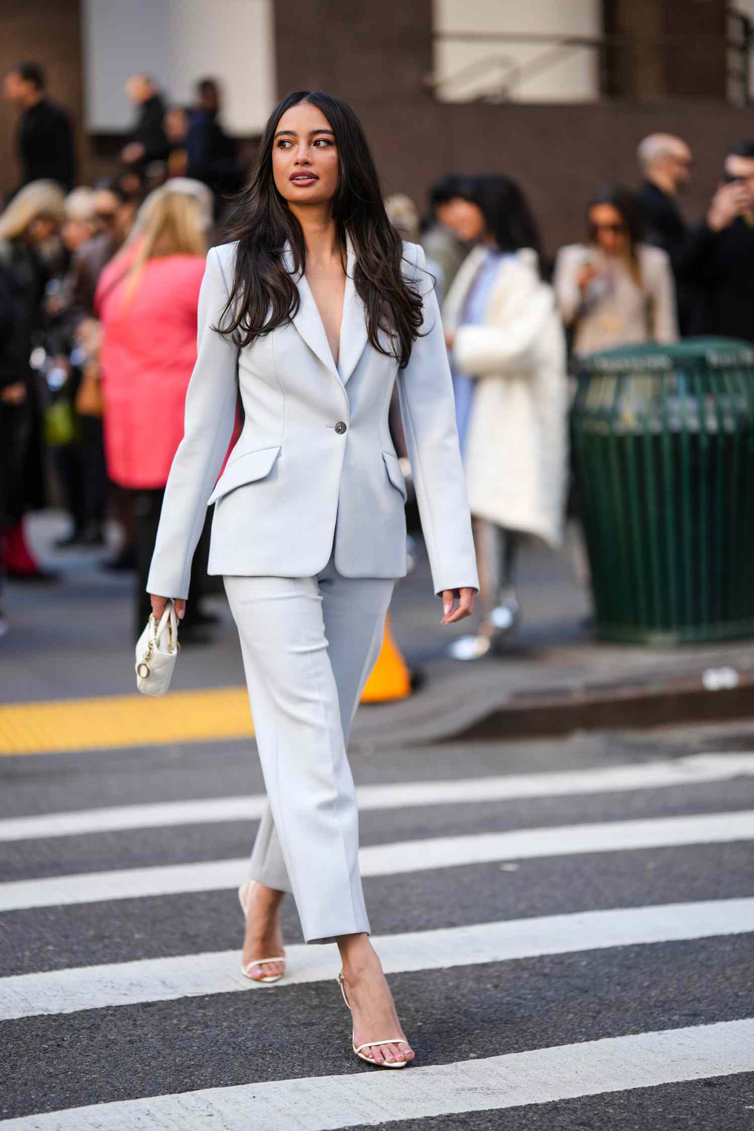 Woman wearing white and pale blue suit for Sagittarius outfits