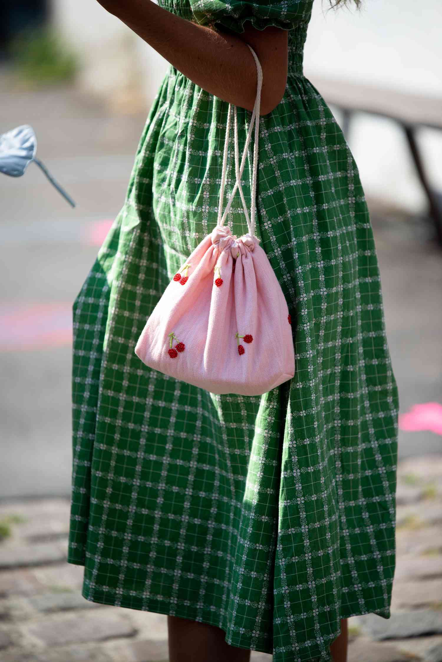 Showing Cancer fashion, Cancer Style, and how to dress like a Cancer zodiac sign, a woman carries a printed pattern bag