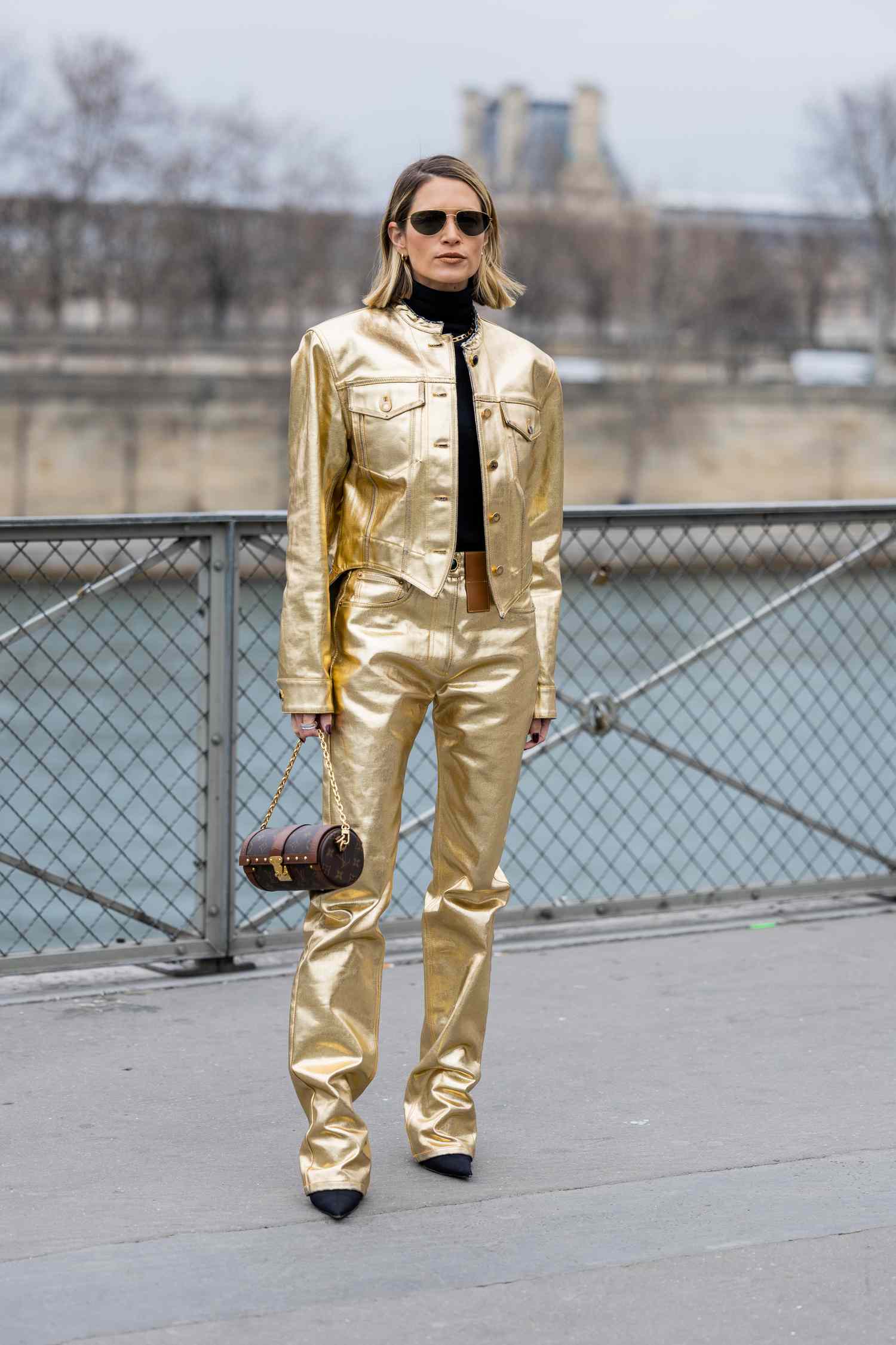 Person in a metallic gold jacket and pants with black turtleneck