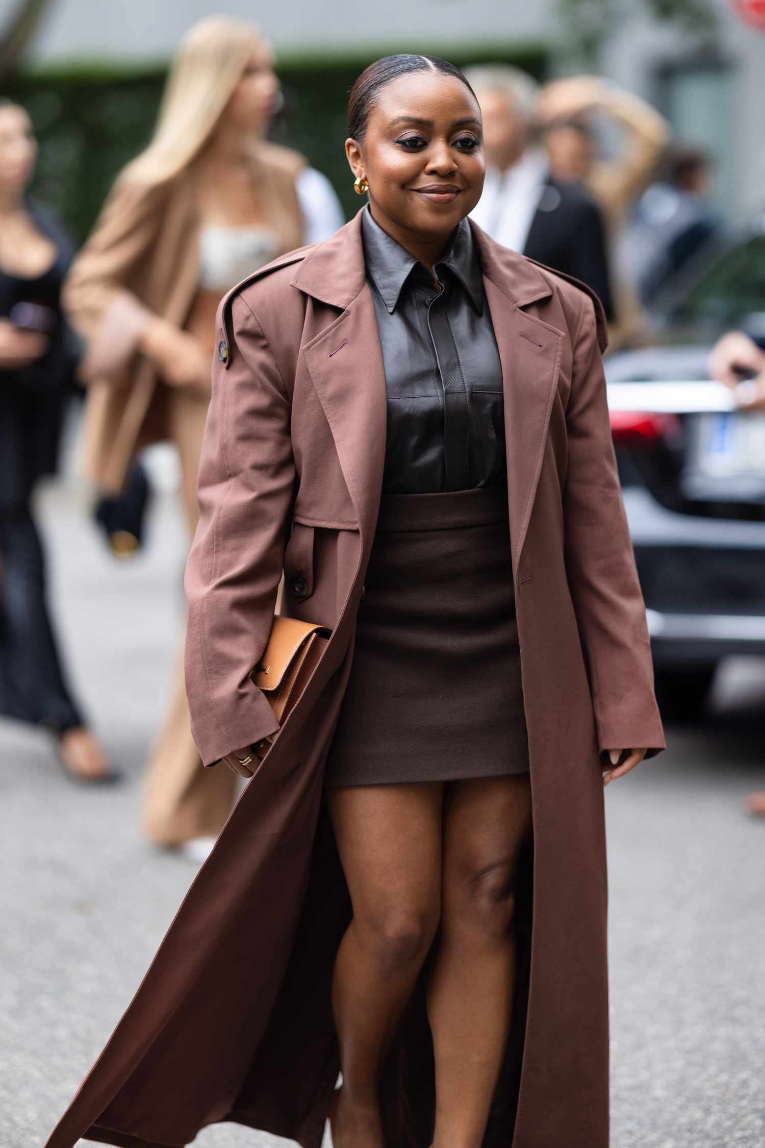 Quinta Brunson wears a leather button-down shirt with a trench coat, a 2023 Scorpio outfit for women.