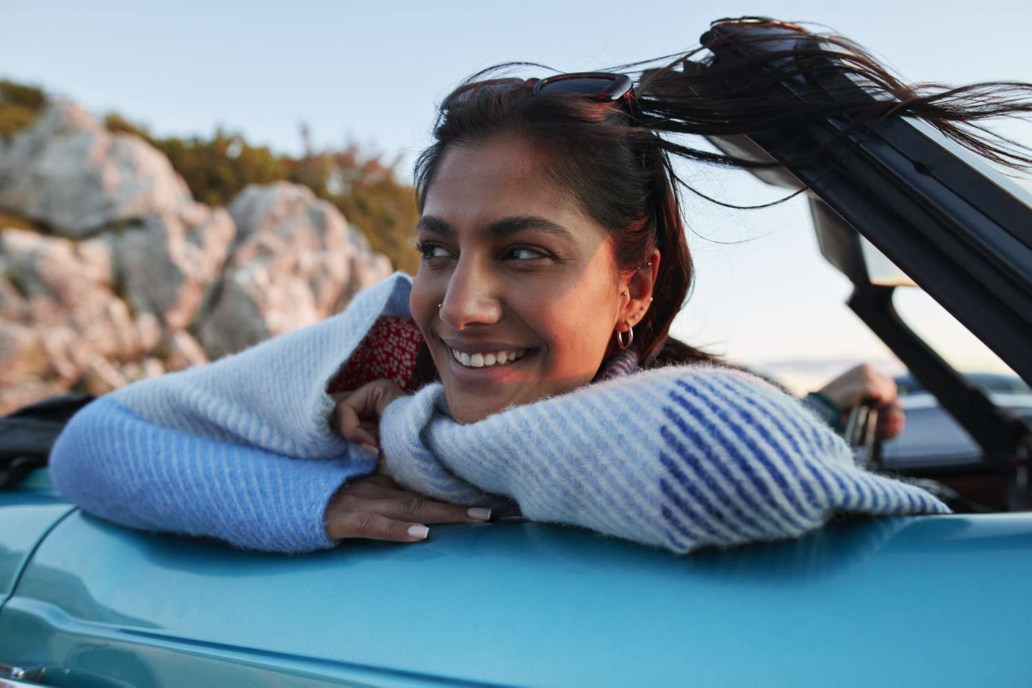 Woman smiling leaning over a car door