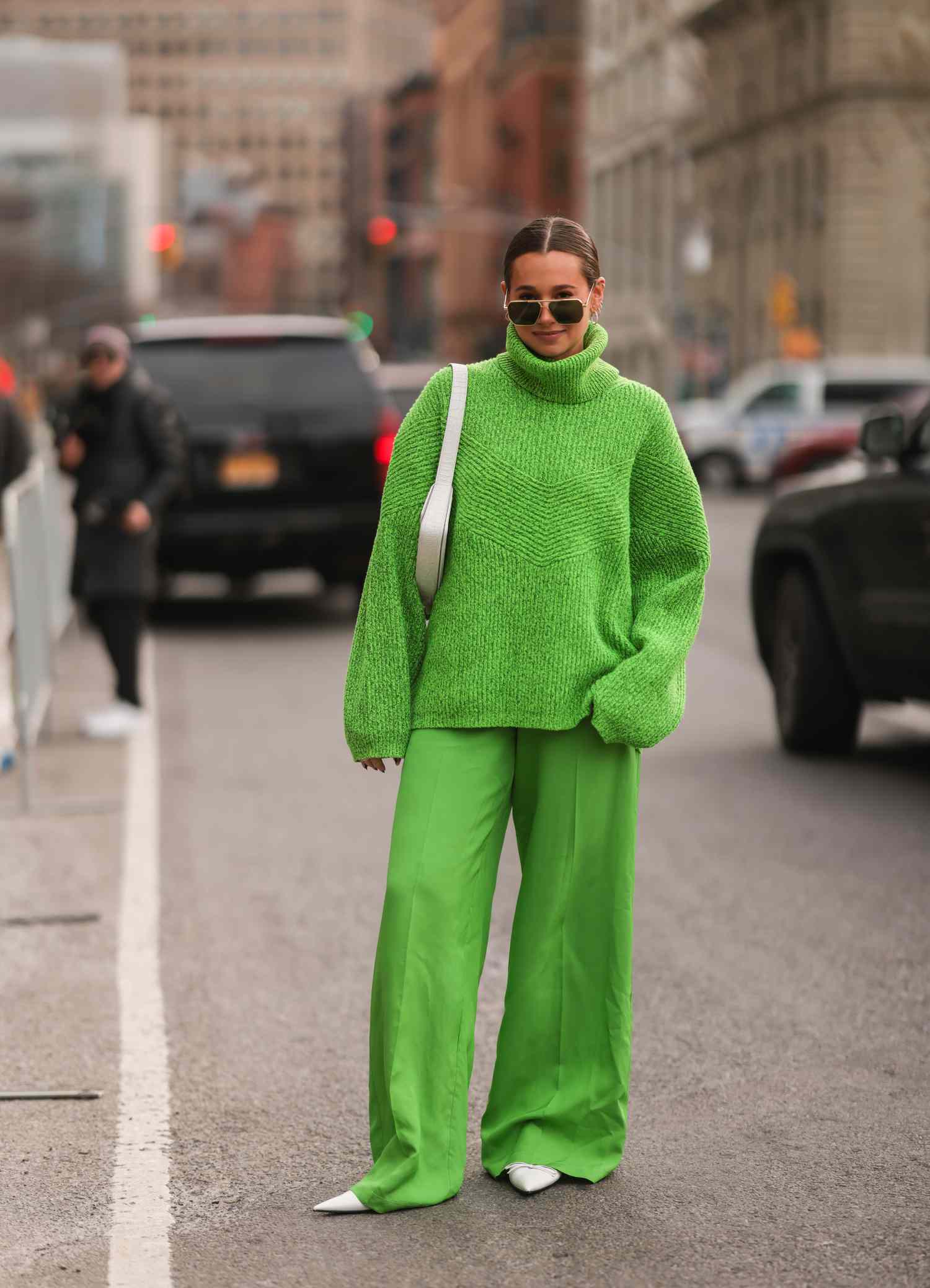 Danielle Bernstein wearing green sweater and pants Sagittarius outfit