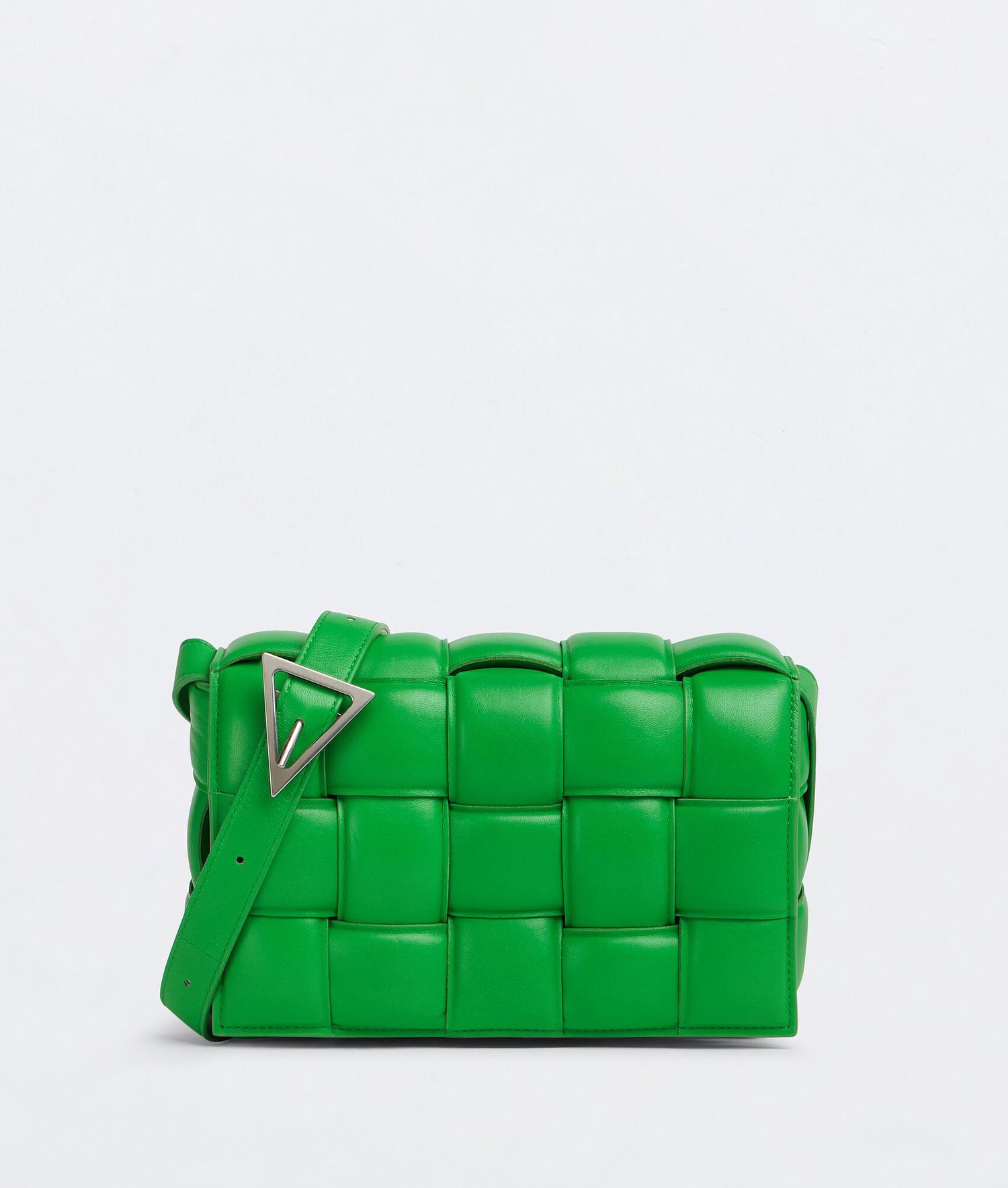 A green Bottega Veneta Padded Cassette Bag, a type of handbag for Aries