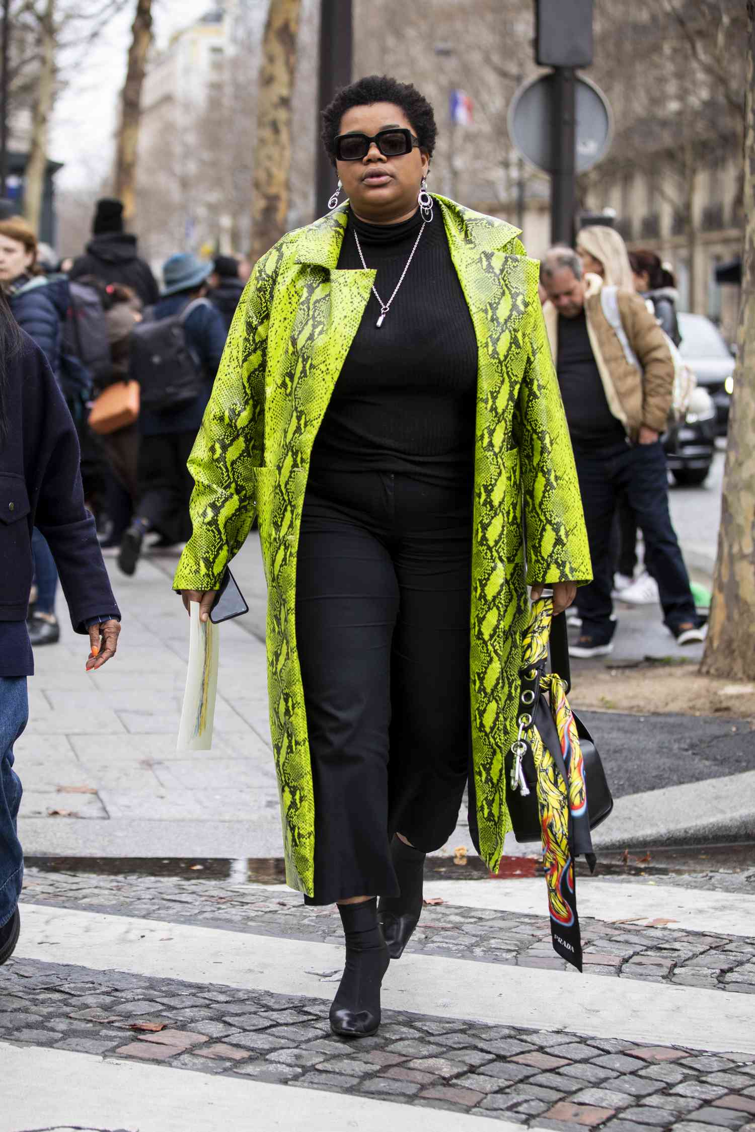 Gabriella Karefa Johnson wears a green statement coat, a 2023 Scorpio outfit for women.