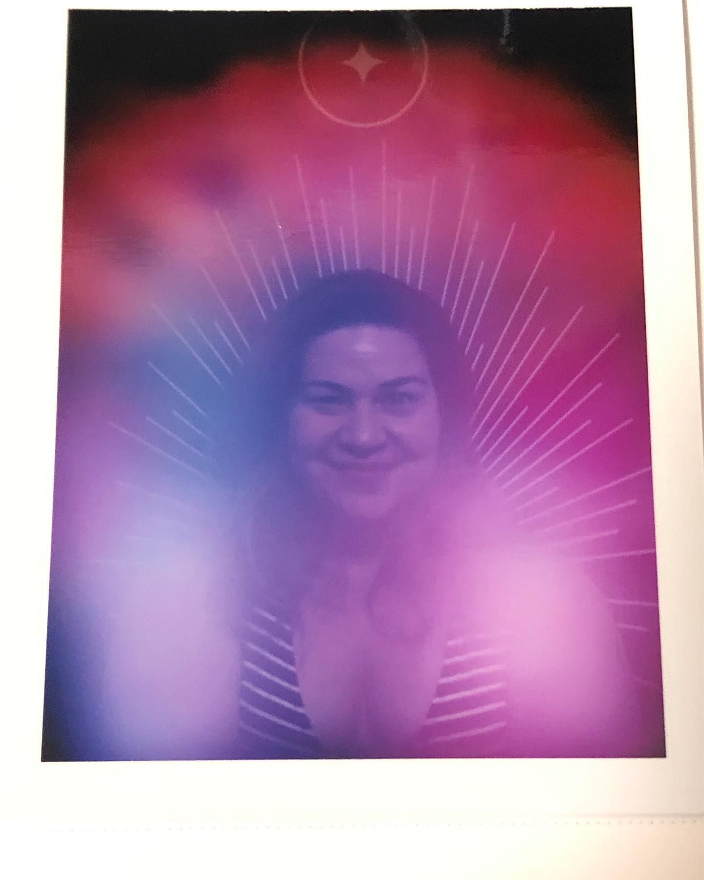 A person's aura reading photo with a cloud of pink, purple, and red surrounding them