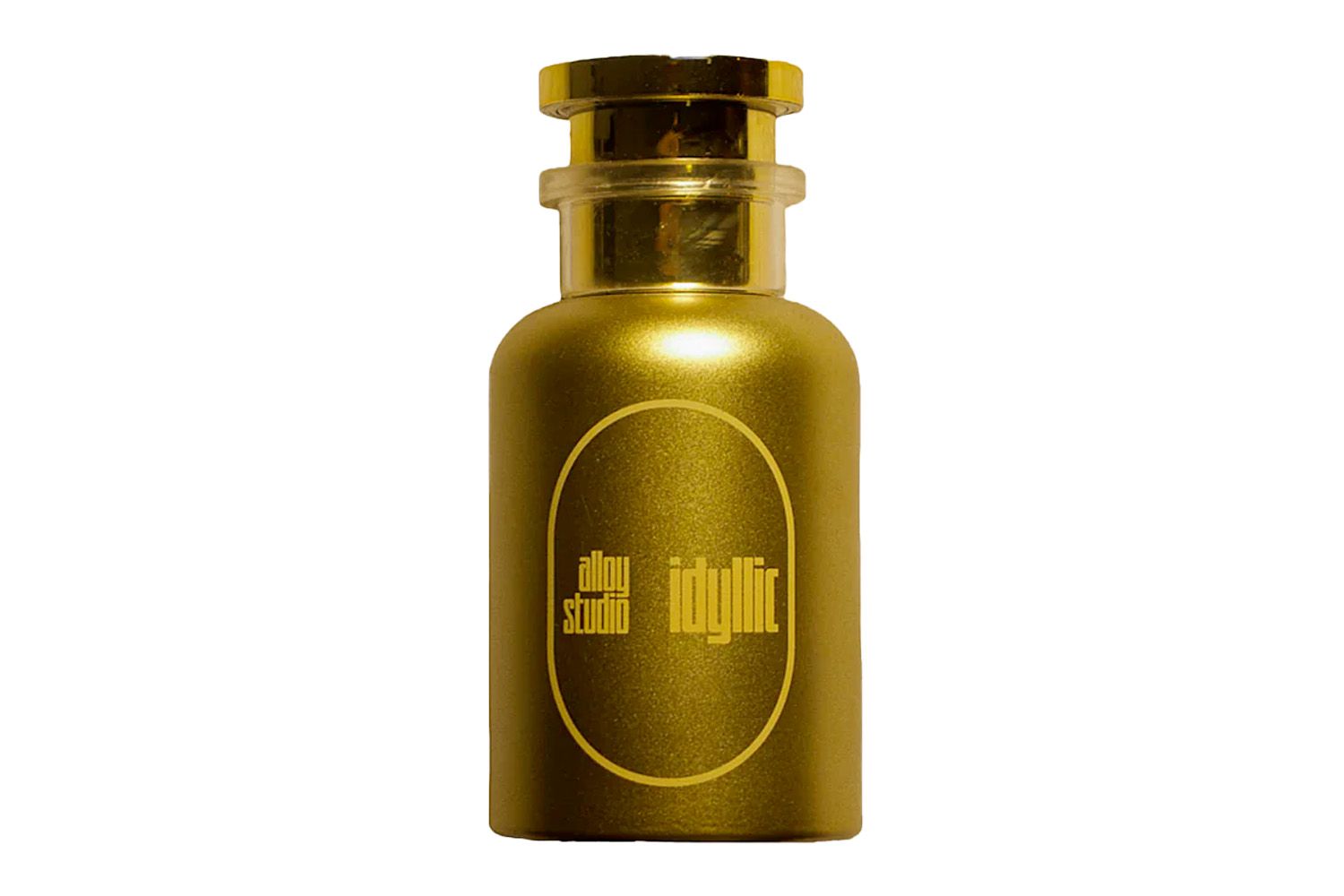 Gold cylindrical perfume bottle with the brand and name 'idyllic' displayed on the front