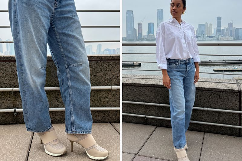 A person modeling blue jeans with heeled sneakers outdoors