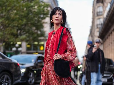 Molly Chiang walking down the street in Paris in a red dress and vest