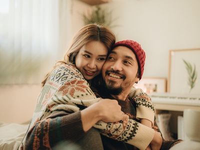 Two people hug and smile at each other