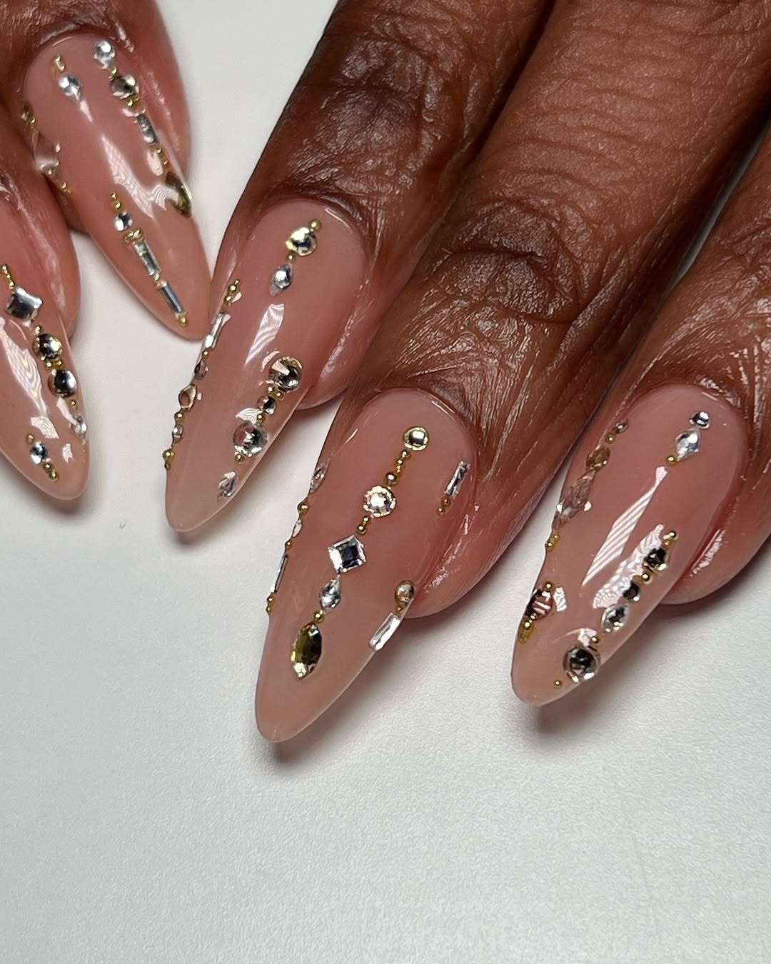 Closeup of manicured nails with gemstones