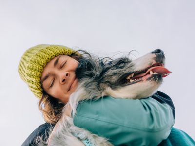 Person embracing a dog affectionately