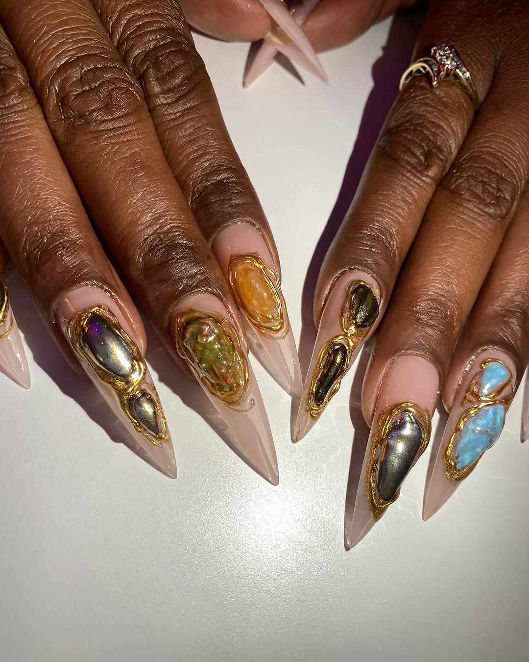 Set of decorative nail extensions featuring embedded gemlike designs