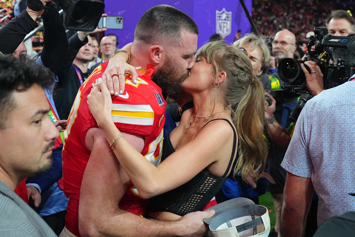  Super Bowl LVIII: Kansas City Chiefs Travis Kelce (87) kisses girlfriend and singer Taylor Swift following victory vs San Francisco 49ers at Allegiant Stadium.