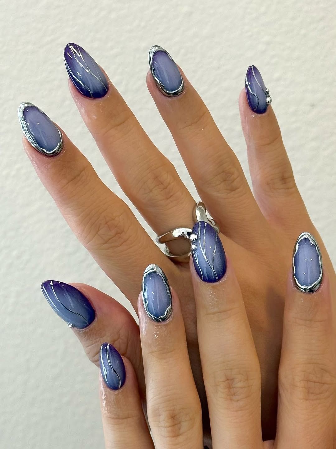 Wellmanicured hands with intricate nail art designs on long nails