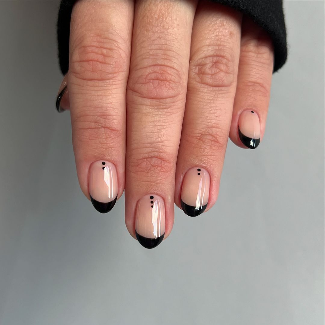 A black French nail design for scorpio season.