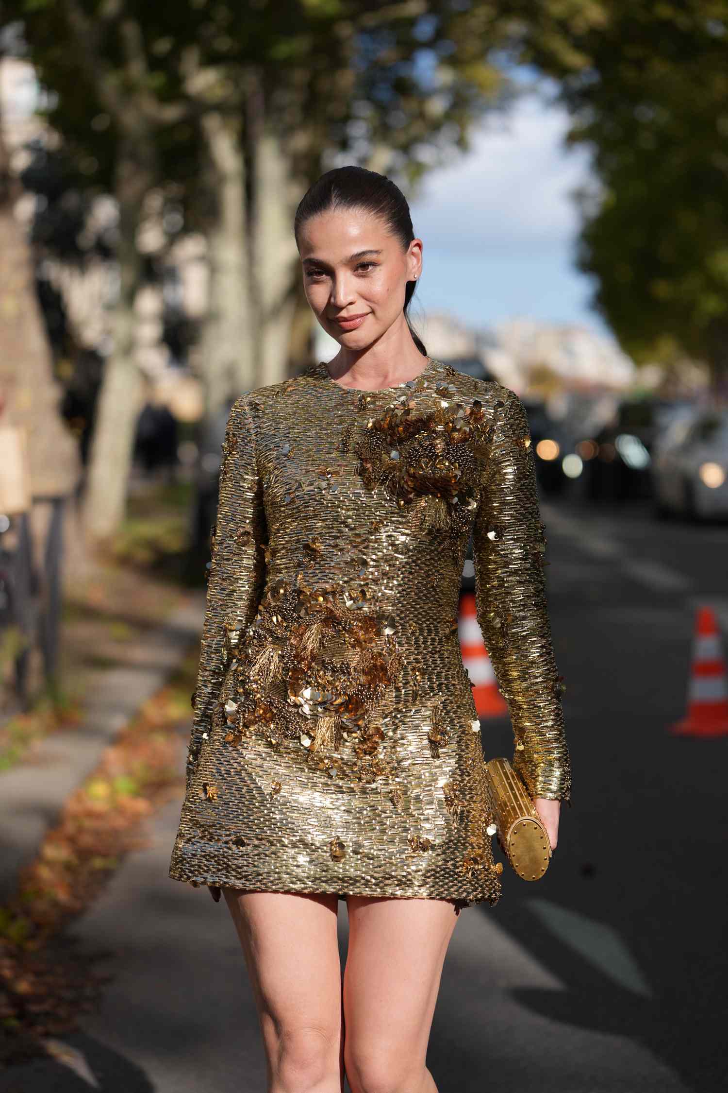 Anne Curtis walking outdoors next to a street wearing a stylish outfit